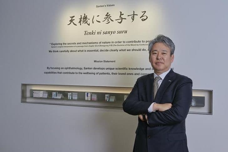 Lee Han-woong, chief executive of Santen Pharmaceutical Korea, standing before a wall displaying the company's values and mission statement