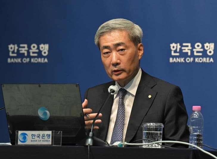Bank of Korea Governor Shin Hyun-song speaks at a podium during a press briefing with the central bank's logo in the background.