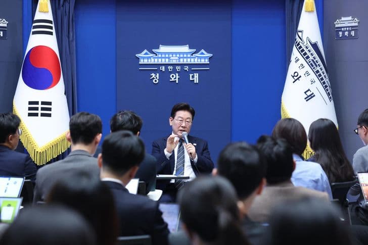 President Lee Jae-myung speaks into a microphone during a press gathering at the presidential office.