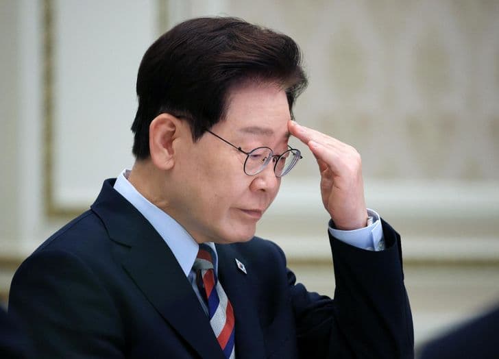 President Lee Jae-myung rubs his forehead during a meeting.